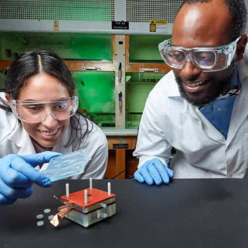 2 scientists working on an experiment