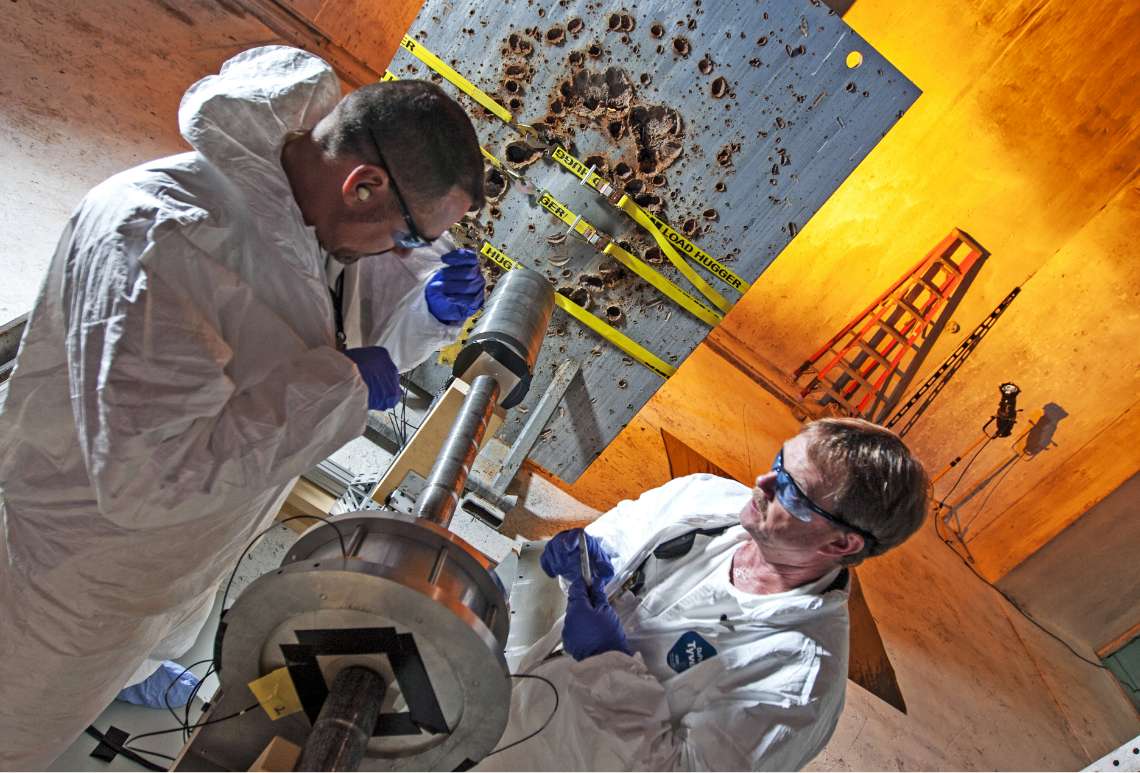 2 physicist working on equipment during experiment
