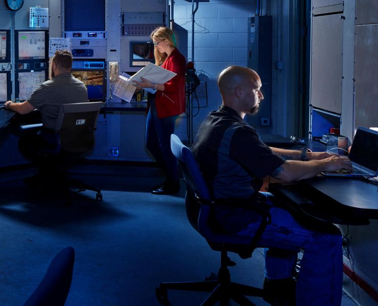 3 Program Operations members working in a lab